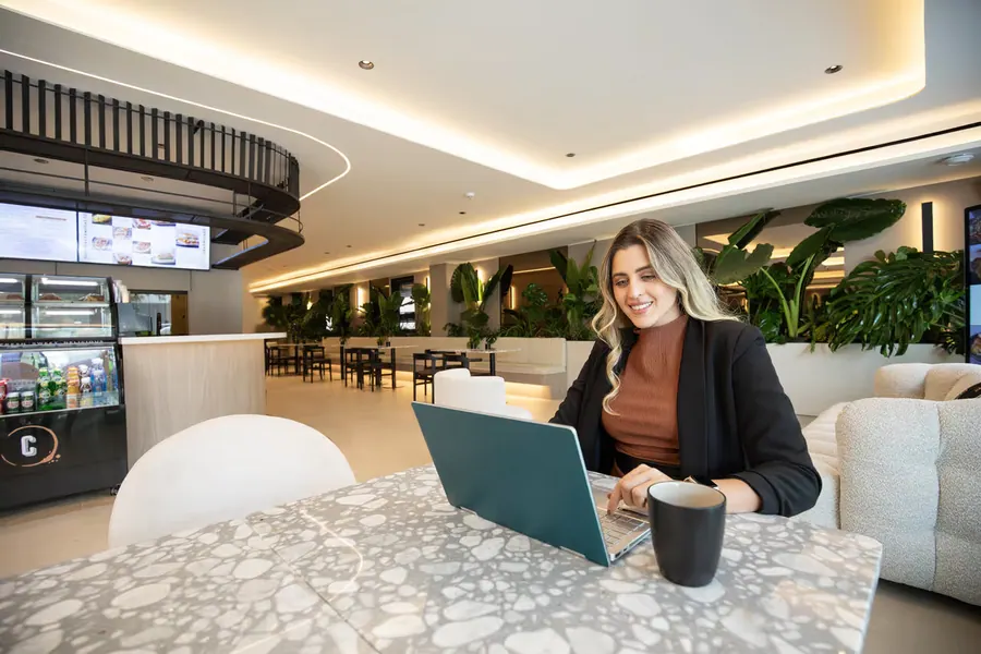 Guest working on a laptop in the coffee area.