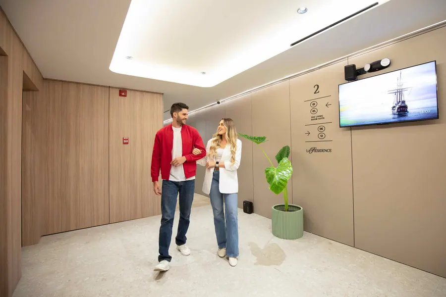 Guests walking through the second floor corridor with wood finishes.