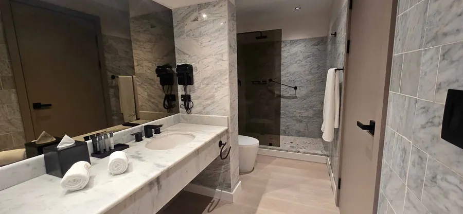 The City Suite marble bathroom with shower.