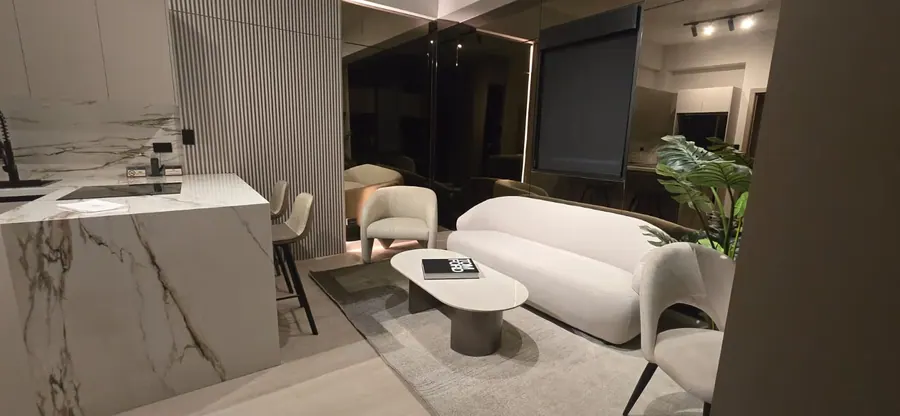 Executive Studio Suite living area with marble island, sofa and kitchen.