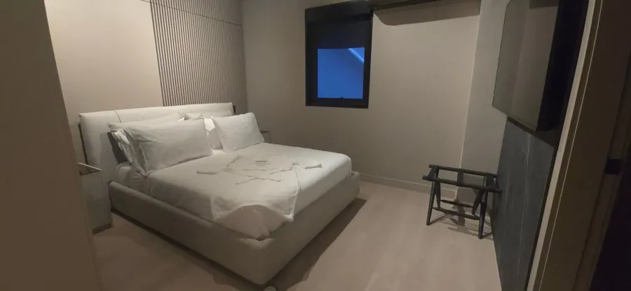 The Living Room Suite bedroom with bed and window.