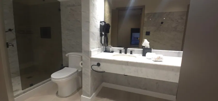 Studio Suite bathroom with marble vanity and shower.