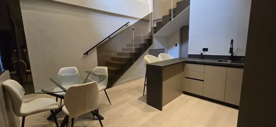 The Urban Loft dining area, glass staircase and kitchen.