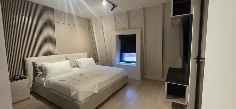The Urban Loft bedroom with king bed and window.